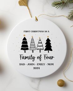 a personalized ornament for a family of four with christmas trees on it