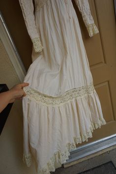 "Size 13 Gunne Sax prairie dress fits smaller - please see measurements. Zips in the back with adjustable tie at the back of the waist. Condition - has one small spot mid skirt to the side - see last photo. Measurements taken across front lying flat 18\" across front armpit to armpit 14\" across front of waist (ties tighter) 59\" length" Long Sleeve Lace Work Maxi Dress For Spring, Cream Floor-length Dress With Lace Work, Off White Lace Maxi Dress With Lace Trim, Floor-length Lace Dress For Daywear, Spring Vintage Long Sleeve Regency Dress, Spring Regency Dress For Vintage Events, Spring Regency Style Dress For Vintage Events, Regency Style Dresses For Spring Vintage Events, Cream Long Sleeve Lace Maxi Dress