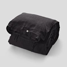 black linen blanket folded on top of each other