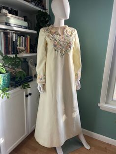 Absolutely beautiful long tunic dress with pretty floral embroidery at neckline and sleeves washed and ready to wear! Would make a fantastic boho wedding dress Fully lined  Back zipper closure fully functional  Overall the dress is in good vintage condition for its age. The embroidery is in excellent shape and completely intact. There is some staining here and there that didn't come out in the wash. The bottom 2.5 inches at the hem has several light marks. There are a few light stains on what wo Festive Bohemian Wedding Dress With Embroidery, Cream Maxi Dress With Resham Embroidery, Long Sleeve Embroidered Floral Wedding Dress, Long Sleeve Embroidered Wedding Dress With Floral Details, Floor-length Wedding Dress With Embroidered Border, Bohemian Dresses With Embroidered Sleeves For Eid, Bohemian Eid Dresses With Embroidered Sleeves, Festive Bohemian Dress With Embroidered Sleeves, Fitted Wedding Dress With Embroidered Sleeves