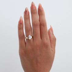 a woman's hand with a ring on it