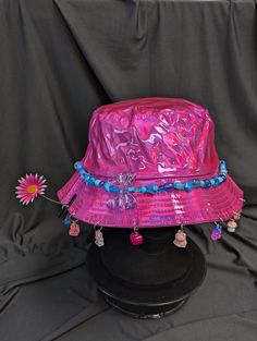 -hat color - pink -bead color -blue -charm color - blue and pink -unisex adult size -inner circumference - 22.5in -crown dip - 3in -brim - 2.25in -NOT machine washable -Perfect for raves and outdoor festivals! Shipping within the US USPS First Class Package 3-9 days USPS Priority Mail 1-5 days USPS Priority Mail Express 1-3 days Shipping International  USPS First Class Mail International  -Varies- USPS Priority Mail International 6-14 days USPS Priority Mail Express International 3-9 days Shipping times are estimated, NOT GUARENTEED.  +International buyers are responsible for all import fees+ +Orders of $50+ may require signature confirmation upon delivery+ Cheap Multicolor Festival Hats, Luxury Blue Festival Hat, Fun Pink Bucket Hat, Trendy Pink Brimmed Mini Hats, Funky Adjustable Party Hats, Pink Wide Brim Hat One Size, Fun Pink Hat, One Size, Pink Curved Brim Bucket Hat For Festival, Pink Wide Brim Mini Hat For Festival