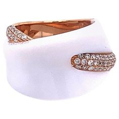 A smooth piece of white onyx sparkles on top of this modern styled ring. It is accented with 0.57 carats of round brilliant cut diamonds set in 18k rose gold. A fashionable piece that can compliment any outfit, day or night. Ring Size 5.75 Luxury White Diamond Ring With Single Cut Diamonds, Luxury White Single Cut Diamond Ring, Luxury White Rings With Diamond Accents, Modern White Diamond Ring With Accents, Luxury White Rings With Vvs Clarity, Luxury White Diamond Ring With Pave Setting, Modern White Diamond Ring With Single Cut Diamonds, Modern White Diamond Ring With Polished Finish, Modern White Diamond Ring With Vvs Clarity