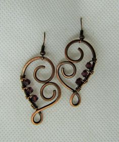 This listing is for one pair wire wrapped Heart Amethyst Crystal in Copper Earrings. Please read all listings carefully and if you have questions, address them to me and I will answer quickly. I thank you for shopping with Sparrow Song. New Pendant by Sparrow Song: Heart Shaped Copper and Crystal Earrings, measures 4.5 by 2.5 cms. Please inquire for your own tailor custom earrings with a choice of metal, crystal or stone. See what my customers are saying about my jewelry https://www.etsy.com/you Wrapping Crystals, Wire Wrapped Heart, Diy Wire Jewelry Rings, Wire Wrap Earrings, Wire Ideas, Wire Jewelry Earrings, Wire Jewelry Patterns, Wire Craft, Wire Wrap Jewelry Designs