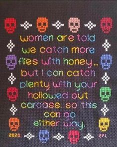 a crocheted afghan with words written in different colors and skulls on the side