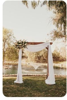 an outdoor wedding setup with white drapes and flowers