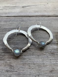 "1.75\" sterling silver hand-forged hoops wrapped with a flashy labradorite. Oxidized silver or plain silver finish. You choose at checkout ! 2.25\" drop from hypoallergenic niobium earwires. Handmade in NY" Artisan Small Hoop Sterling Silver Jewelry, Bohemian Hand Forged Sterling Silver Earrings, Artisan Silver Round Hoop Earrings, Artisan Hammered Dangle Hoop Earrings, Hand Forged Sterling Silver Dangle Jewelry, Bohemian Sterling Silver Hammered Earrings, Silver Hammered Bohemian Earrings, Bohemian Hammered Sterling Silver Earrings, Bohemian Silver Hammered Earrings