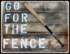 a baseball bat sitting on top of a wooden sign that says go for the fence