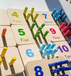 colorful wooden numbers arranged on top of each other with magnets attached to the boards