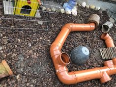 the pipes are laying on the ground next to some rocks and other things around them