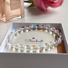 This glossy Mermaid glass bracelet is a treasure. Designed to attract those with enchanting style, these stones are made from exquisitely quality glass lined with brilliant colors to reflect light like sparkling rainbow moonstones. Also called Quartz Glowing Aura Moonstone is one of the top trending bracelets today. Also a great and stylish gift, for people who love modern design and want to add litlle sparkles in their lives. All jewelry comes in premium packaging, gift ready, plus a stylish po Trending Bracelets Bead, Mermaid Glass Bracelet, Bracelet For Girlfriend, Glowing Aura, Black Obsidian Necklace, Casual Bracelets, Mermaid Glass, Bracelets Women, Trending Bracelets