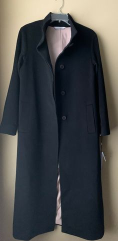 Fleurette Black Stand Collar Cashmere Long Coat  Color; Black Size: 10 (armpit to armpit 21", shoulder 18", sleeve 23 3/4", length 48", vent 15 1/2") Stand collar, long coat. Button closure. 100% cashmere Lining: 100% acetate Track Page Views With Auctiva's FREE Counter Black Long Outerwear With Button Closure, Fitted Black Wool Coat For Office, Black Wool Outerwear For Career, Fitted Black Wool Coat For Business Casual, Fitted Black Pea Coat With Button Cuffs, Classic Business Outerwear With Covered Buttons, Classic Office Outerwear With Covered Buttons, Classic Black Long Pea Coat, Classic Long Black Pea Coat