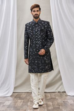 Black sherwani with floral embroidery and mandarin collar. Paired with cream churidar.
Component: 2
Pattern: Embroidered
Type Of Work: Floral
Neckline: Mandarin
Sleeve Type: Full Sleeves
Fabric: Art Banarasi Silk, Dupion Art Silk
Color: Black
Other Details: 
Floral embroidery
Front buttons
Note: Pocket square worn by the model is not for sale
Occasion: Wedding - Aza Fashions Designer Resham Embroidery Kurta For Reception, Festive Kurta With Naqshi For Reception, Naqshi Bandhgala In Jamawar For Reception, Designer Sherwani With Straight Kurta For Reception, Designer Kurta With Resham Embroidery For Designer Wear, Formal Chikankari Embroidery Straight Kurta Bandhgala, Formal Straight Kurta Bandhgala With Intricate Embroidery, Designer Raw Silk Sherwani For Reception, Designer Sherwani With Resham Embroidery For Eid