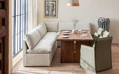 a living room filled with furniture and a wooden table