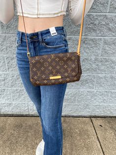 A Medium Size Bag with Two Straps, one small chain strap and one leather cross body strap. LV Favorite MM Color: Brown Louis Pre-Owned Authentic For more information please email care@lizziesboutique.com Favorite Mm Louis Vuitton, Lv Favorite Mm, Lv Favorite, Favorite Mm, Bag With Chain, Leather Cross, Luxury Brand, Chain Strap, Leather Crossbody