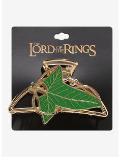 the lord of the rings leaf brooch pin in gold and green on a black background