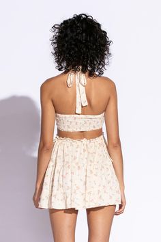 STYLE INFORMATION: Get your Texas boho vibes on in the Sundown Peach Floral Print Sundress!. Peach floral print Swiss dot fabric shapes this cute dress that has a halter V-neckline with tie straps, and a cutout waist.. The open back wraps around to the sides to create a cutout effect above the attached mini skirt. Ruffle trim and side ties decorate the cutout waist. DETAILS & CARE: Rayon/Polyester. Dry Clean. Imported. SHIPPING: We offer free shipping for all orders in the Continental US. Spring V-neck Halter Dress With Crisscross Straps, Sleeveless Tie Back Halter Top For Brunch, Vacation V-neck Halter Top With Tie Back, Halter Neck Dress With Tie Straps For Day Out, Spring Tie Back Backless Halter Dress, Spring Backless Halter Dress With Tie Back, Spring Tie-back Backless Halter Dress, Triangle Top Dress For Spring And Summer, Tie Back Halter Neck Sundress For Brunch