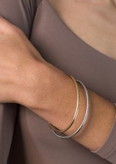 This is what lightweight stacking dreams are made of with Jenny Birds water-durable and lightweight designed Dane Bangle Set. Details: gold ion-plated steel rhodium ion-plated steel finish: high polish tension closure Measurements: Dane Bangle Set - 6" (2-pk) circumference: 6 1/2" inner diameter 57 x 47mm / 2.24 x 1.86" cuff thickness 3mm / 0.12" height: 3mm / 0.12" weight: 4.1g About Jenny BirdFounded in 2008, Jenny Bird jewelry brand is celebrated for its modern, quality craftsmanship and bold Modern Everyday Bangle With Bracelet Strap, Sleek Adjustable Jewelry With Polished Finish, Modern Yellow Gold Metal Cuff Bracelet, Sleek Polished Bangle Jewelry, Sleek Polished Bangle Bracelet, Modern Gold Tarnish-resistant Bangle, Adjustable Modern Bangle Tarnish Resistant, Modern Hoop Bangle For Everyday, Modern Hoop Bangle For Everyday Wear