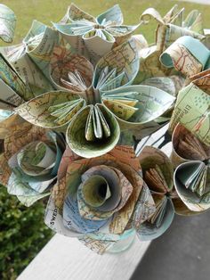 a bouquet of paper flowers sitting on top of a window sill