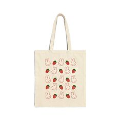 a tote bag with strawberries and rabbits on it