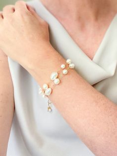 Make a classic and elegant statement with this multi-layered mixed pearl bracelet. Two handcrafted strands of differently shaped and sized pearls create a versatile accessory suitable for weddings, brunches, work, and more. The lobster clasp and extender ensure a secure and adjustable fit. Length: 7.5 inches plus 1.5-inch extender Materials: gold fill, cultured freshwater pearls GIFTING ~ Jewelry gift box included. ~ I am happy to ship directly to the recipient.  Enter their address during checkout. ~ If you would like a gift note included in the package, please leave the text of the note in the "Add a note to Marsh Creek Jewelry" message box at checkout. FREE SHIPPING ~ Orders ship within 2 business days. ~ Free shipping is First Class ~ Priority Mail and Express Shipping upgrades are ava Gold Pearl Bracelet With Pearl Drop, Elegant Single Strand Baroque Pearl Bracelets, Elegant Baroque Pearl Bracelet With Pearl Charm, Elegant Baroque Pearl Bracelet Jewelry, Wedding Baroque Pearl Chain Bracelet, Elegant Pearl Bracelet With Pearl Chain, Elegant Adjustable Single Strand Pearl Bracelet, Elegant Bracelet With Baroque Pearl Charm, Baroque Pearl Bracelets For Wedding