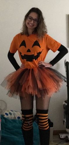 a woman is dressed up as a pumpkin