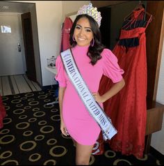 a woman wearing a pink dress and tiara