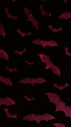 many red bats flying in the dark