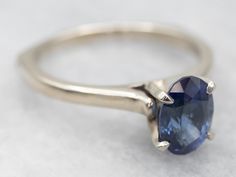 This is a well-proportioned ring, classic and sophisticated. The brightly polished sides have a great heft to them, and this is comfortable on the finger, with a rich feel. We've set the center with a bright blue Ceylon sapphire that has glittering navy and cobalt highlights and plenty of sparkles.Metal: 14K White GoldGem: Sapphire 1.85 CaratsGem Measurements: 6.2 x 8.6 mm, OvalAccents: Diamond .01 Carats, J in Color, I in ClarityRing Size: 9Marks: "14Kt" Stamped on the inside band Gold Sapphire Engagement Ring, White Gold Sapphire, Ceylon Sapphire, Pocket Watch Chain, Sapphire Engagement Ring, Watch Chain, Sapphire Engagement, Engagement Rings Sapphire, Pearl Pendant