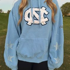 Vintage University of North Carolina at Chapel Hill Hoodie with added star rhinestones. One of a kind, embroidered, and super cute! So comfy!  Wash delicate and dry with low heat or hang dry Size XL. Feels true to size, not very oversized. The model is a size small. It is used and second hand but there are no stains or rips. North Carolina University, Carolina Hoodie, Star Hoodie, Vintage University, University Of North Carolina, Chapel Hill, Blue Hoodie, Carolina Blue, North Carolina