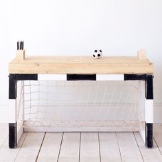 a soccer goalie's desk with a soccer ball on top