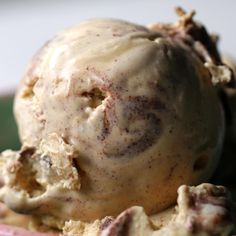 a scoop of ice cream sitting on top of a pink bowl