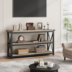 a living room with a couch, coffee table and television mounted on the wall above it