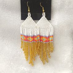 White, Gold, Light Blue, Pink, Mauve, Orange, And Yellow Beaded Fringed Earrings On Gold Tone Hooks. Diamond Design Band In The Fringes. 4 Inches Long. White Beaded Fringe Festival Jewelry, Festival White Beaded Fringe Jewelry, White Festival Jewelry, Bohemian White Jewelry For Summer, Colorful Beaded White Jewelry For Festivals, White Beaded Earrings For Summer, Summer Gold Beaded Dangle Earrings, White Bohemian Jewelry With Dangling Beads, White Jewelry With Colorful Beads For Festival