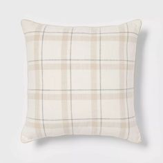 a beige plaid pillow on a white background