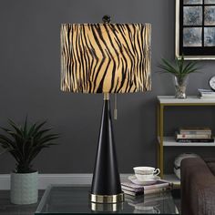 a zebra print lamp sitting on top of a glass table next to a brown chair