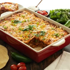 a red casserole dish filled with mexican food