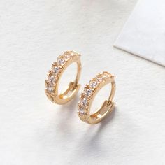 These 14K Solid Gold Huggie Hoop earrings will be your favorite everyday pairs. Set with quality Moissanite crystals that sparkle from every angle. Smaller in size-Great for cartilage or second piercings. 14K Gold For this style as a single earring, click here. Moissanite Crystals Hypoallergenic, lead and nickel free Thickness 2mm Diameter Sizes: Inside 6mm,Outside 9mm Click Snap closure #ES038-G Cubic Zirconia Huggie Cartilage Earrings With Prong Setting, Yellow Gold Cubic Zirconia Huggie Cartilage Earrings, Gold Minimalist Hoop Earrings, Hypoallergenic Yellow Gold Cubic Zirconia Hoop Earrings, Gold Minimalist Round Cut Hoop Earrings, Single Round Cut Cubic Zirconia Huggie Earring, Gold Diamond Huggie Cartilage Earrings, Classic Round Huggie Earrings With Sparkling Stones, Small Hoop Earrings In Yellow Gold With Sparkling Stones