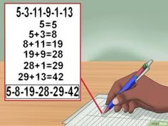 a person writing on a piece of paper with numbers