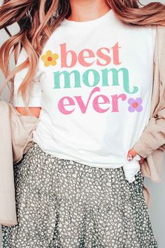 BEST MOM EVER GRAPHIC TEE** PLUS SIZE AVAILABLE: 10738X-TS-PLUS **- Premium 4.2 oz., 100% airlume combed and ringspun cotton- Retail fit- Unisex sizing- Shoulder taping- Sideseamed- Pre-shrunk Style: CASUAL Print / Pattern: BEST MOM EVER Silhouette: TEE Fit: UNISEX Neck Line: CREW Sleeve: SHORT Made In: USAFabric Contents: 100% COTTON Stretch fabric Non-sheer fabric Care Instructions: Machine wash warm, inside out, with like colors.Tumble dry low.Medium iron.Do not iron decoration.Do not dry cle Cocktail Dress Curvy, Casual Cocktail Dress, Curvy Swimwear, Sweater Hat, Iron Decoration, Best Mom Ever, Trendy Graphic Tees, Los Angeles Style, Spring Sweater