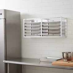 a stainless steel kitchen with an oven on the wall and other items on the counter