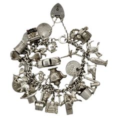 Delightful English sterling silver charm bracelet with a heart lock and safety chain. There are thirty four charms: telephone, horses head and horseshoe, ballet dancer, owl, horse rider, opening shoe with bride and bridegroom inside, 1940 silver three pence coin, saxophone, Nelson's column, hare, bucket, shoe, horse rider, anchor, opening car, golf clubs, church, coffee pot, moving roller, hat, key, St. Christopher, garland, elephant, tennis rackets and ball, car, tankard, horse head, boxing gloves, pixie, spinning good luck, typewriter, garland, and 1860 Victorian coin. Measuring length approximately 18.5 cm / 7.28 inches. The heart lock and clasp is marked silver. The bracelet is in very good condition, with scratching as expected. We have given the bracelet a light clean, some of the pa Horses Head, Measuring Length, Car Golf, Opening Car, Tennis Rackets, St Christopher, Heart Lock, Sterling Silver Charm Bracelet, Safety Chain