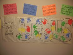 a bulletin board with the word jesus written on it and handprints in different colors