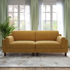 a living room scene with focus on the couch and window curtained drapes in the background