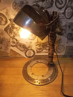 a lamp that is sitting on top of a wooden table in front of a wall