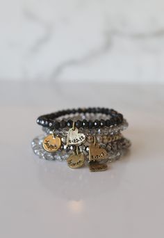 Add some bling to your wrist with our Personalized Crystal Stacks! You can personalize your stack bracelet with a name, date, initials, or a word of choice on a simple, classic disc charm. With neutral colors and faceted beads that shine and shimmer in the light, you can be reminded of a motivating word, memory, or special loved one whenever you look down at your wrist! A perfect gift for the everyday stack wearing lover! *Elastic stack bracelets are made with 6mm faceted crystals *Personalized Everyday Stackable Round Name Bracelet, Adjustable Hand Stamped Charm Bracelet For Everyday, Everyday Adjustable Hand Stamped Charm Bracelet, Inspirational Black Jewelry For Everyday Wear, Black Hand Stamped Jewelry For Everyday, Black Hand Stamped Everyday Jewelry, Everyday Black Stretch Bracelet With Custom Name, Stack Bracelets, Stack Bracelet