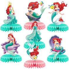 the little mermaids are sitting on top of each other in their dresses and tails