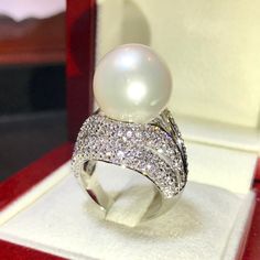 Enormous SOUTH SEA PEARL, absolutely natural color and luster, 14.5 mm in size, surrounded by 257 pieces of hand-set E/VVS superb quality diamonds, weighting at 3.05 carats. Set in handcrafted, one of a kind 18K solid white gold ring, weighting at 13.5 grams. The pearl is naturally cultured from South Australia Sea, its luster is extra fine, AA+ grade with 85% clean surface. SUGGESTED RETAIL PRICE: $13,800 The ring is hand crafted to a high standard and is NOT mass machine produced and is brand Luxury White Diamond Ring For Party, Dazzling White Rings For Evening, Luxury White Rings For Evening, Luxury White Evening Rings, White Diamond Rings For Evening, White Diamond Ring For Party In Fine Jewelry Style, White Diamond Ring For Party, Fine Jewelry, White Diamond Ring For Party, White Diamond Party Ring