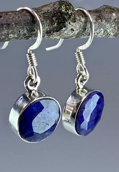 A beautifully eye-catching and sophisticated deep blue faceted raw Sapphire and sterling silver dangle earrings. The feature stone is set in classic half-bezel. Weight - 4 grams (2 grams each) The earrings measure - 1.0 cm in diameter and 0.4 cm deep.  The total drop 2.7 cm. Product made hypoallergenic with pure 925 silver and nickel free. About the stone: Most of the 'big three' gemstones - emeralds, rubies and sapphires - are in some way enhanced or treated. Only the very pure, perfectly colou Blue Polished Drop Earrings, Blue Drop Earrings With Polished Finish, Sapphire Faceted Jewelry For Anniversary, Faceted Sapphire Jewelry For Anniversary, Blue Faceted Round Jewelry, Blue Round Faceted Jewelry, Silver Sapphire Earrings With Gemstones, Modern Blue Faceted Jewelry, Blue Bezel Set Earrings For Formal Occasions