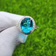 Item Details:  Gemstone: Lab Created Paraiba Tourmaline  Main stone  Size: 10x12MM Base Material: 925 Sterling Silver Plating: Silver, Gold, Rose Gold Platted Our processing time is  up-to 7 working days  and our standard shipping run up-to 15 to 18 days. If you want express shipping please message us  on Etsy. Order Cancellation : We accept order cancellation within 24 hours of placing order, Otherwise We don't cancel the order. Return/Exchange: Return or Exchange accepted within 14 days of del Formal Oval Topaz Ring With Halo Setting, Formal Oval Emerald Ring With Gemstone Accents, Formal Oval Topaz Ring With Gemstone Accents, Oval Emerald Ring With Gemstone Accents In Sterling Silver, Oval Topaz Ring With Gemstone Accents, Oval Blue Topaz Diamond Ring, Oval Emerald Ring With Gemstone Accents, Oval Gemstones With Halo Setting For Wedding, Silver Oval Emerald Ring With Halo